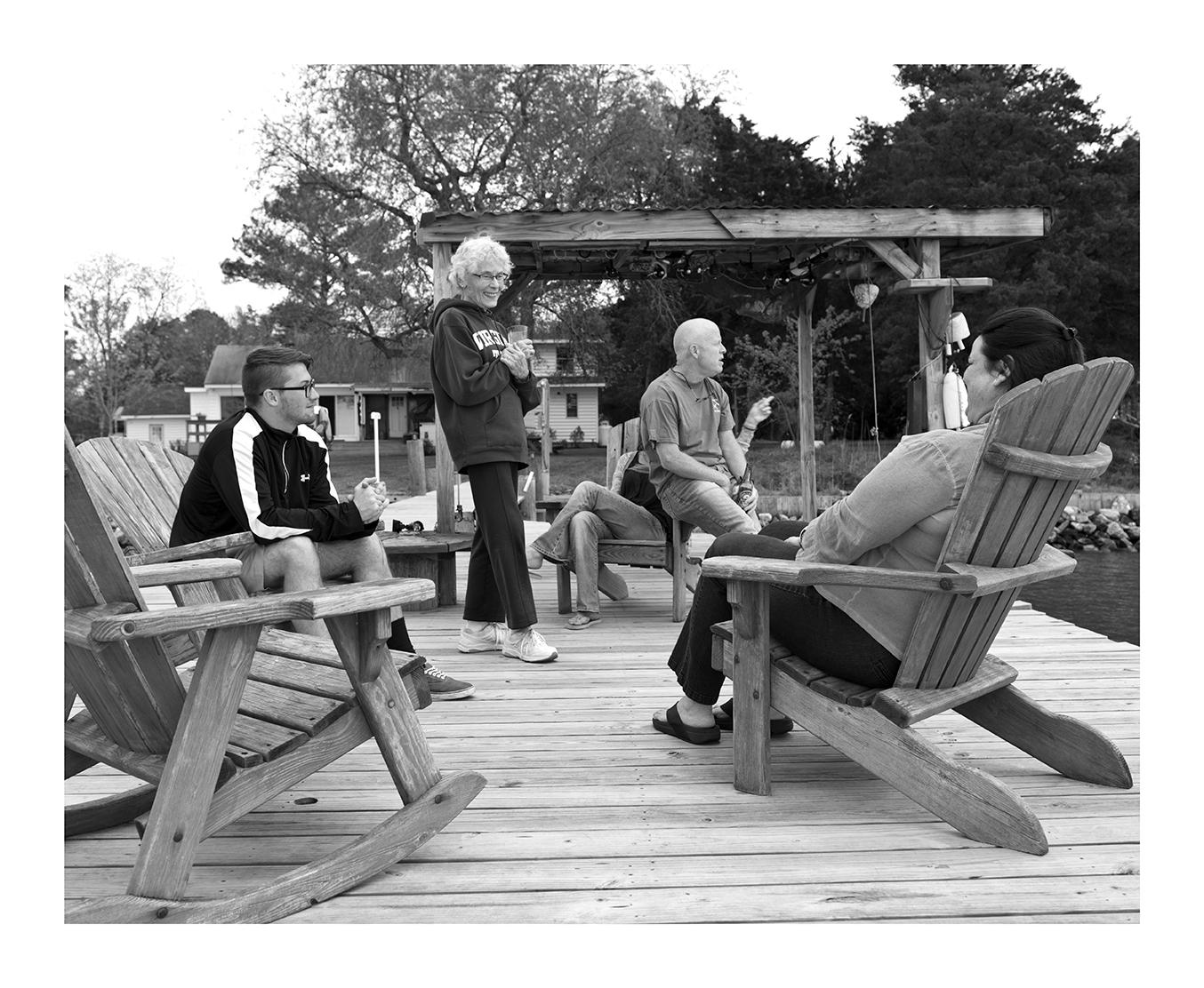 Friends and Family gather to share a sunset on a Nanticoke River dock, Bivalve, Maryland